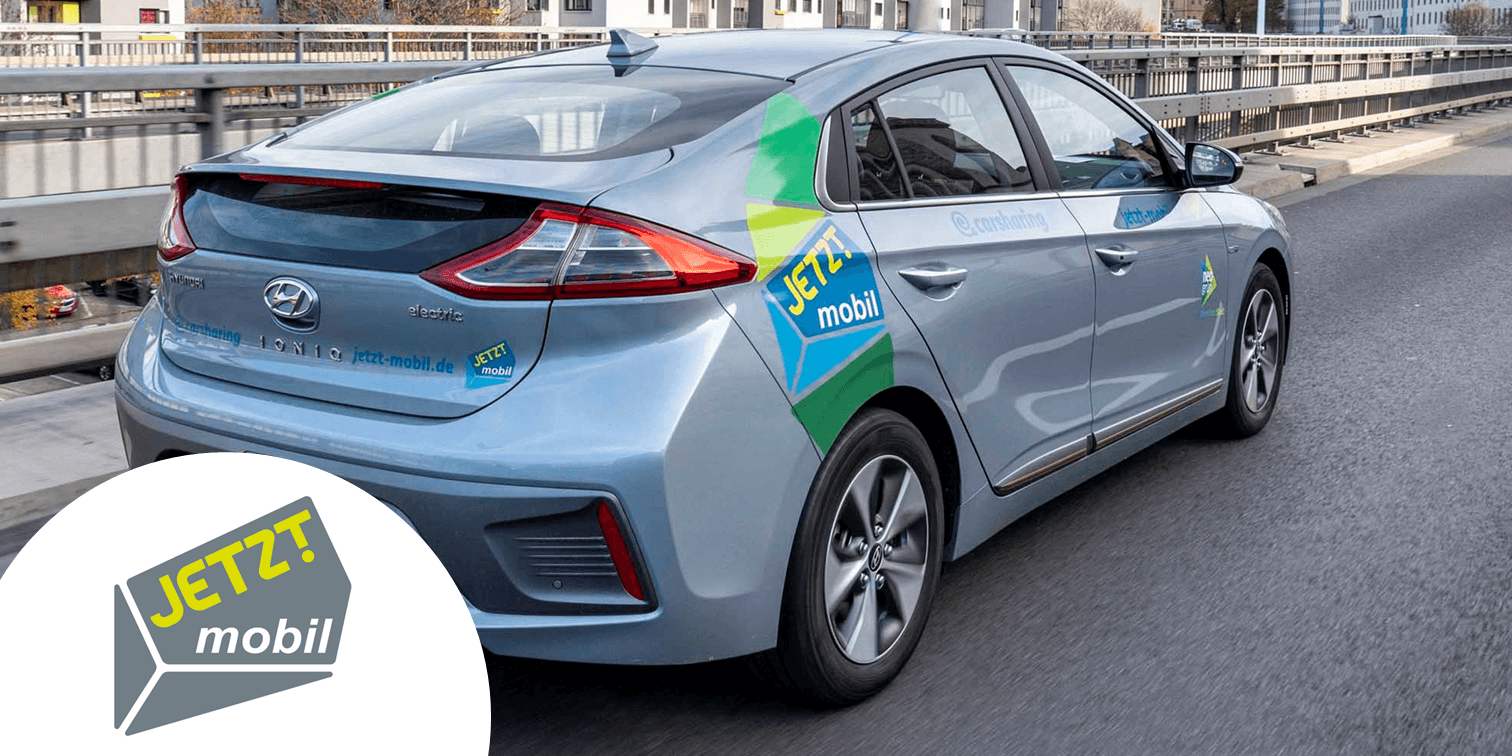 Silbernes Auto und Logo des Carsharing-Partners Jetzt Mobil. copyright JETZT mobil GmbH